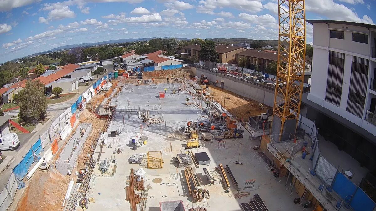 Drone image of Brookland's The Banksia under construction with scaffolding and trucks on the ground.